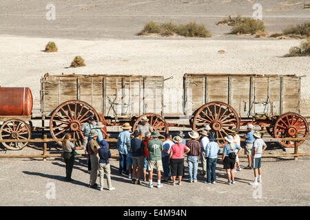 Ranger-led tour at twenty mule team wagon, Harmony Borax Works Interpretive Trail, Death Valley National Park, California USA Stock Photo