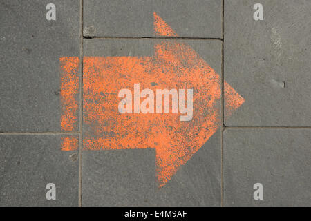 Arrow shape painted onto the pavement Stock Photo