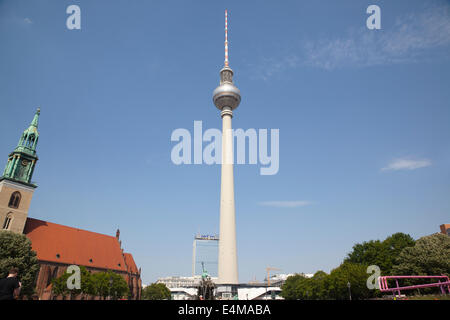 Germany, Berlin, Mitte, Fernsehturm TV Tower seen from St Marienkirche and Neptunbrunnen in Alexanderplatz. Stock Photo