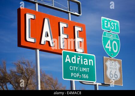 Road and cafe signs in Adrian, Texas, the midpoint of US Route 66. Stock Photo