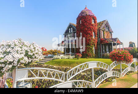House covered in flowers at Dubai's Miracle Garden, largest natural flower garden in the world Stock Photo