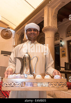 Serving coffee at the Sheikh Mohammed Centre for Cultural Understanding in Dubai, UAE. Stock Photo