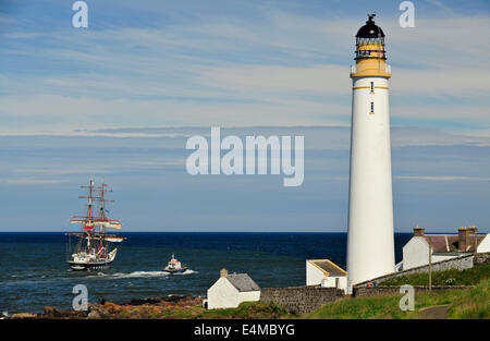 The Stavros S Niarchos a British brig-rigged tall ship is escorted past Scurdie Ness Lighthouse, Montrose, Angus, Scotland. Stock Photo