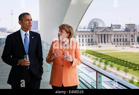 FILE - A handout picture dated 19 June 2013 shows US President Barack Obama talking to German Chancellor Angela Merkel (CDU) on the roof of the Federal Chancellery inBerlin, Germany. Merkel turns 60 on 17 July 2014. Photo: Steffen Kugler/Bundespresseamt/dpa Stock Photo