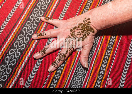 Freshly applied henna dye applied during desert safari outside Dubai, UAE. The henna is allowed to dry, then rubbed off, leaving Stock Photo