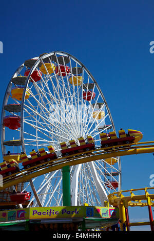 Ferris wheel and roller coaster at Pacific Park, Santa Monica Pier, Santa Monica, Los Angeles, California, USA Stock Photo