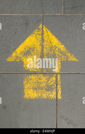 Arrow shape painted onto the pavement Stock Photo