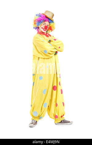 Full length portrait of a funny male clown in a yellow costume Stock Photo