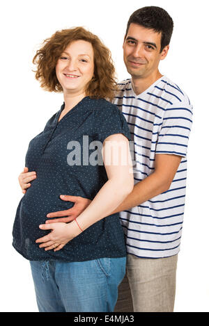 Beautiful expectant couple standing in embrace isolated on white background Stock Photo