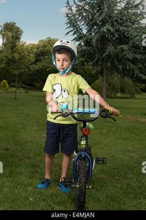 Boy ,6 with a push bike  in the park,Cheam Park,Surrey,UK Stock Photo