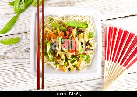 Noodles with pork and vegetables in plum sauce Stock Photo