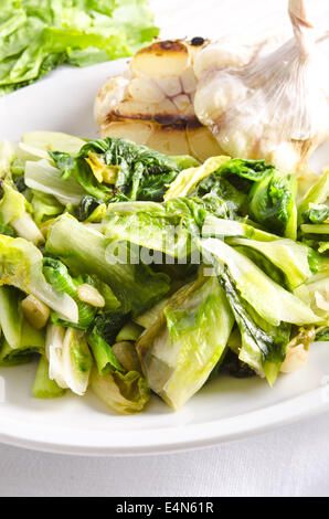 Baked Romaine lettuce with garlic and pine cores Stock Photo - Alamy