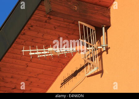 Antenna on house wall Stock Photo