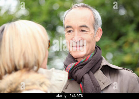mature gentleman looking at his lady fondly Stock Photo