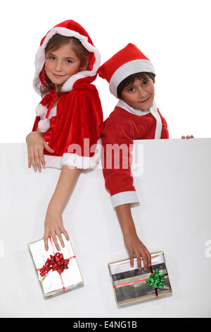 Children dressed as Santa Claus Stock Photo