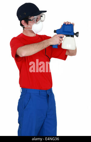 Man holding a paint sprayer Stock Photo