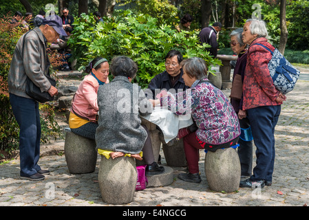 Shanghai, China - April 7, 2013: old people playing chinese cards at the city of Shanghai in China on april 7th, 2013 Stock Photo