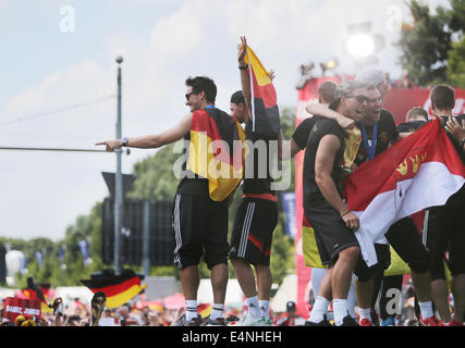 Germany's players cheer on stage during the welcome reception for Germany's national soccer team in front of the Brandenburg Gate, Berlin, Germany, 15 July 2014. The German team won the Brazil 2014 FIFA Soccer World Cup final against Argentina by 1-0 on 13 July 2014, winning the world cup title for the fourth time after 1954, 1974 and 1990. D Stock Photo