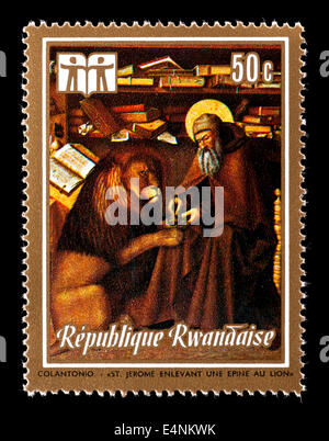 Postage stamp from Rwanda depicting the Colantonia painting 'St. Jerome Removing Thorn From Lion's Paw' Stock Photo