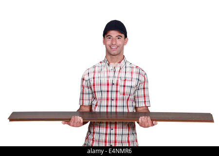 Worker carrying plywood Stock Photo