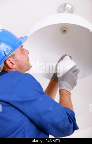 Installing a new light bulb Stock Photo