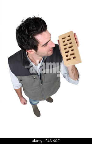 Builder holding brick Stock Photo
