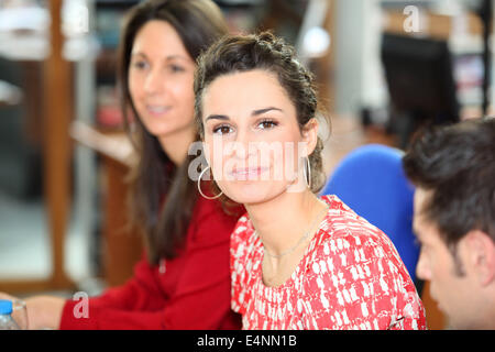 brunette in office with colleagues Stock Photo