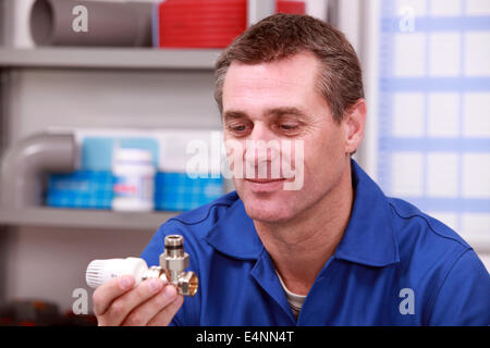 Plumber with a thermostatic radiator valve Stock Photo