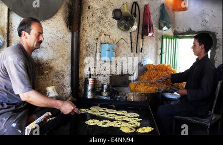 Ghazni, Afghanistan. 15th July, 2014. Afghan people make traditional sweets at a sweet factory in Ghazni province, Afghanistan, July 15, 2014. © Rahmat/Xinhua/Alamy Live News Stock Photo