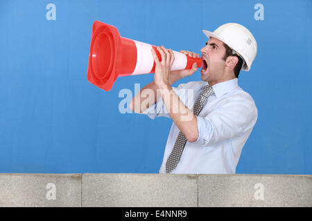 Man in safety hat screaming Stock Photo