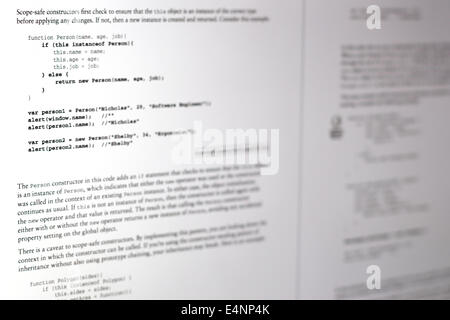 This image shows a javascript textbook being read on a digital screen, the code is highlighted in bold Stock Photo