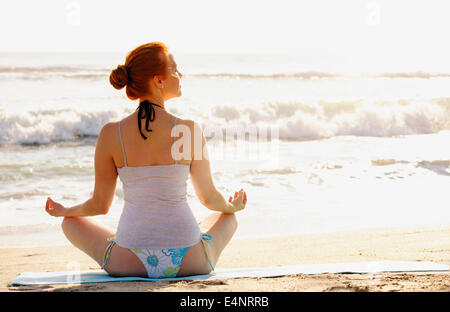 USA, Florida, Palm Beach, Woman practicing yoga on beach Stock Photo