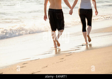USA, Florida, Palm Beach, Couple walking on beach, low section Stock Photo