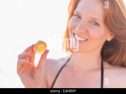 Portrait of woman holding shell Stock Photo