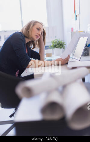 Side view of business woman in office Stock Photo