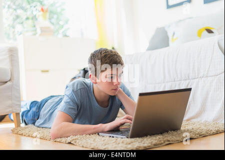 Teenage boy (16-17) using laptop Stock Photo
