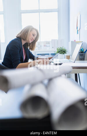 Side view of business woman in office Stock Photo