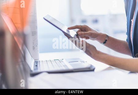 Close up of hands holding digital tablet Stock Photo