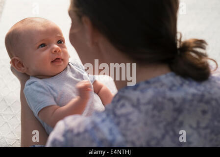 Mother holding baby boy (2-5 months) Stock Photo