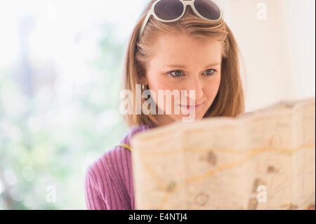 Portrait of young woman looking at map Stock Photo