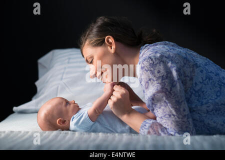 Woman playing with baby boy (2-5 months) Stock Photo