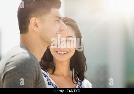 Young couple smiling in sunlight Stock Photo