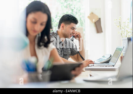 Young man and woman working in office Stock Photo