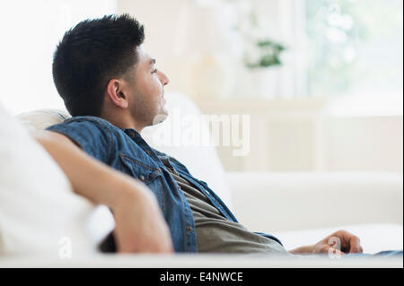 Young man relaxing on sofa Stock Photo