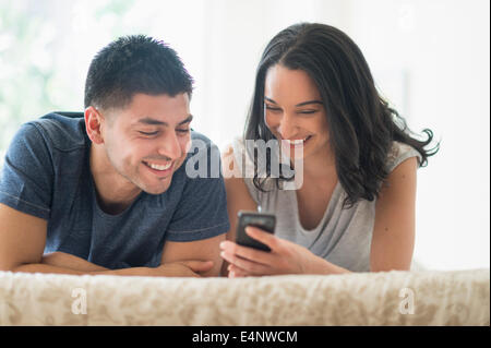 Young couple relaxing on bed Stock Photo