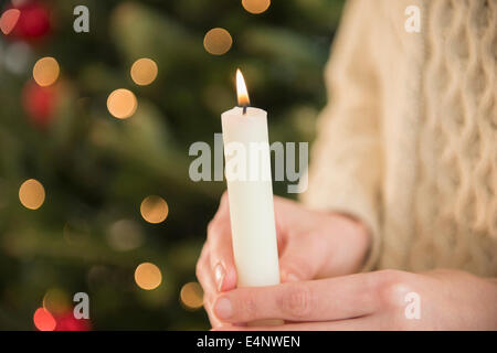 Studio Shot of female's hands holding candle Stock Photo