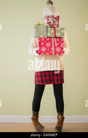 Woman holding stack of presents Stock Photo