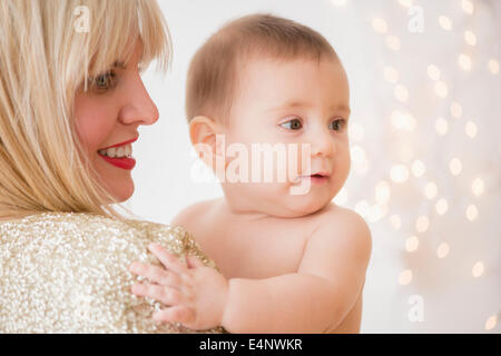 Studio Shot of woman holding baby (6-11months) Stock Photo