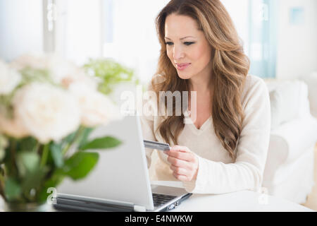 Woman doing online shopping on laptop Stock Photo