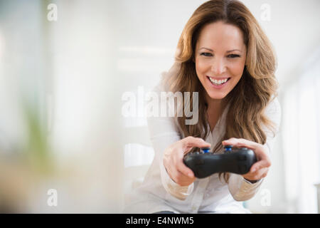 Woman playing video game Stock Photo